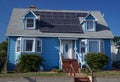 Solar panels on the roof of a vintage, traditional bungalow style house