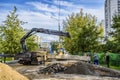 Workers and technicians perform repair work on the road to replace the roadbed