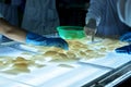 Workers are testing the color of squids for exporting in a seafood factory in Vietnam