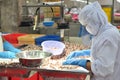 Workers are testing the quality of octopus for exporting in a seafood processing factory