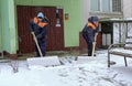 Workers in uniform with big shovels. Snow removal on the city streets Royalty Free Stock Photo