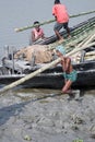 Workers unload cargo from the boat in Gosaba, India