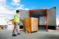 Workers Unloading Heavy Pallet Boxes into Container Truck. Loading Dock Warehouse. Supply Chain, Warehouse Shipping. Royalty Free Stock Photo