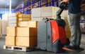 Workers Unloading Package Boxes on Pallets in Storage Warehouse. Supplies Shipment, Supply Chain, Distribution Warehouse Shipping. Royalty Free Stock Photo