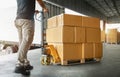 Workers Unloading Packaging Boxes on Pallet in Warehouse. Loading Cartons, Cardboard Boxes. Shipping Warehouse. Shipment Boxes.