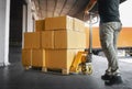 Workers Unloading Packaging Boxes on Pallets to The Warehouse. Cartons Cardboard Boxes. Shipping Warehouse. Delivery. Shipment Box Royalty Free Stock Photo