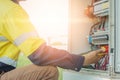 Workers use Clamp meter to measure the current of electrical wires produced from solar energy for confirm to systems working