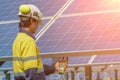 Workers use Clamp meter to measure the current of electrical wires produced from solar energy for confirm to systems working