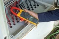 Workers use Clamp meter to measure the current of electrical wires produced from solar energy for confirm to systems working Royalty Free Stock Photo