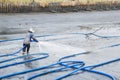 Workers use high pressure water cleaning shrimp pond