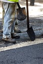 Workers using asphalt paver tools during road construction. Royalty Free Stock Photo