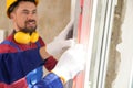 Workers using bubble level for installing window, closeup Royalty Free Stock Photo