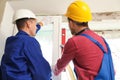 Workers using bubble level for installing window Royalty Free Stock Photo