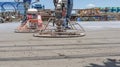 Workers are using concrete polishing machines for cement after Pouring ready-mixed concrete