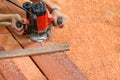 Workers using electric routering on the wood and sawdust Royalty Free Stock Photo