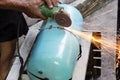 Workers using a metal grinding machines to cut workpieces made o