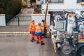 workers using sewerage truck and large pipe working on the clogged street rain water Royalty Free Stock Photo