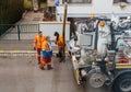 workers using sewerage truck and large pipe working on the clogged street rain water Royalty Free Stock Photo