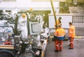 workers using sewerage truck and large pipe working on the clogged street rain water Royalty Free Stock Photo