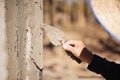 Workers are using a trowel to decorate the cement pillars into a beautiful ridge