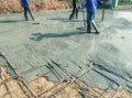 Workers using a wooden spatula for cement after Pouring ready-mixed concrete .