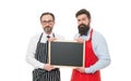 Workers wanted. Men bearded bartender or cook in apron hold blank chalkboard. Bartender with blackboard. Hipster Royalty Free Stock Photo