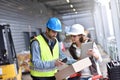 Workers in warehouse checking on recpetion of goods Royalty Free Stock Photo