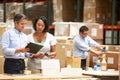 Workers In Warehouse Preparing Goods For Dispatch