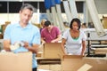 Workers In Warehouse Preparing Goods For Dispatch