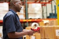 Workers In Warehouse Preparing Goods For Dispatch