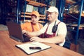 workers in warehouse with rack arrangement stillage on background