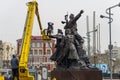 Workers wash the monument.