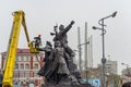 Workers wash the monument.