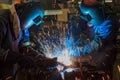 Workers are welding assembly car parts in automotive industrial factory