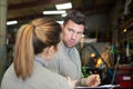 workers welding factory having conversation