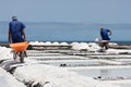 Workers with wheelbarrow at salt extraction La Palma, Canary Islands