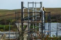 Workers work at a construction site while on scaffolding.Metal construction