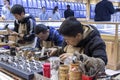 Workers work on the silver jewelry as gift for tourists in Shanghai Yuyuan, China