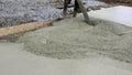 Workers work on site. Detail of casting pump concrete to foundations of family house