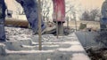 Workers work on site. Detail of casting pump concrete to foundations of family house