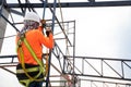 Workers are working on steel roof trusses with Fall arrestor device for worker with hooks for safety body harness on the Royalty Free Stock Photo