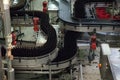 Workflow on beer factory. Conveyer line with many beer bottles. Interior of brewery