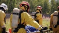 The workflow is in the danger zone. Clip. Four workers in gas masks carry one on a stretcher. First aid in the radiation