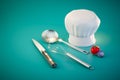 workflow in the kitchen. a whisk, a squeegee, a knife, a chef's cap, a tomato and an onion. 3D render