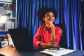 Working African woman with happy glowing and smiling face. Tastemaker. Royalty Free Stock Photo