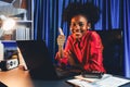 Working African woman with happy glowing and smiling face. Tastemaker. Royalty Free Stock Photo