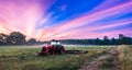 Working agicultural machinery on a sunny spring day - sunset or sunrise Royalty Free Stock Photo