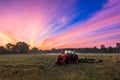 Working agicultural machinery on a sunny spring day - sunset or sunrise Royalty Free Stock Photo
