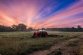 Working agicultural machinery on a sunny spring day - sunset or sunrise Royalty Free Stock Photo