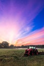 Working agicultural machinery on a sunny spring day - sunset or sunrise Royalty Free Stock Photo